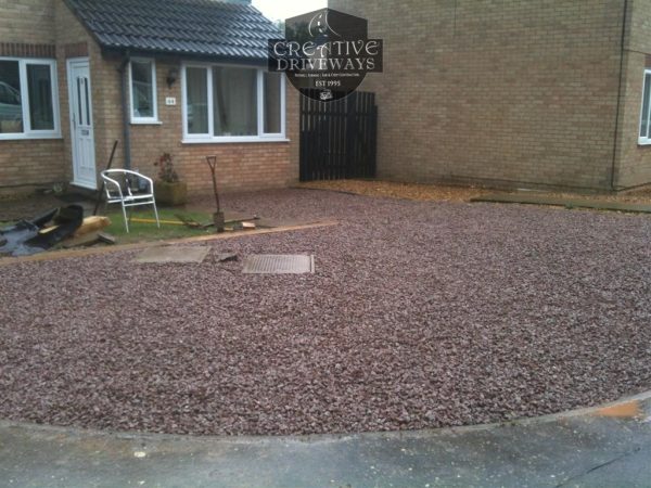 Gravel being laid on a driveway in Crinkle
